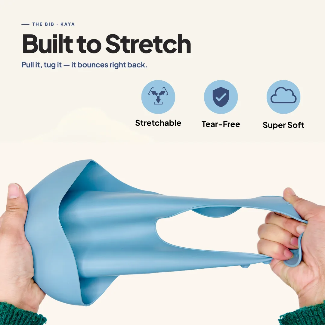 Hands stretching a blue KAYA silicone bib to show how flexible and tear-resistant it is