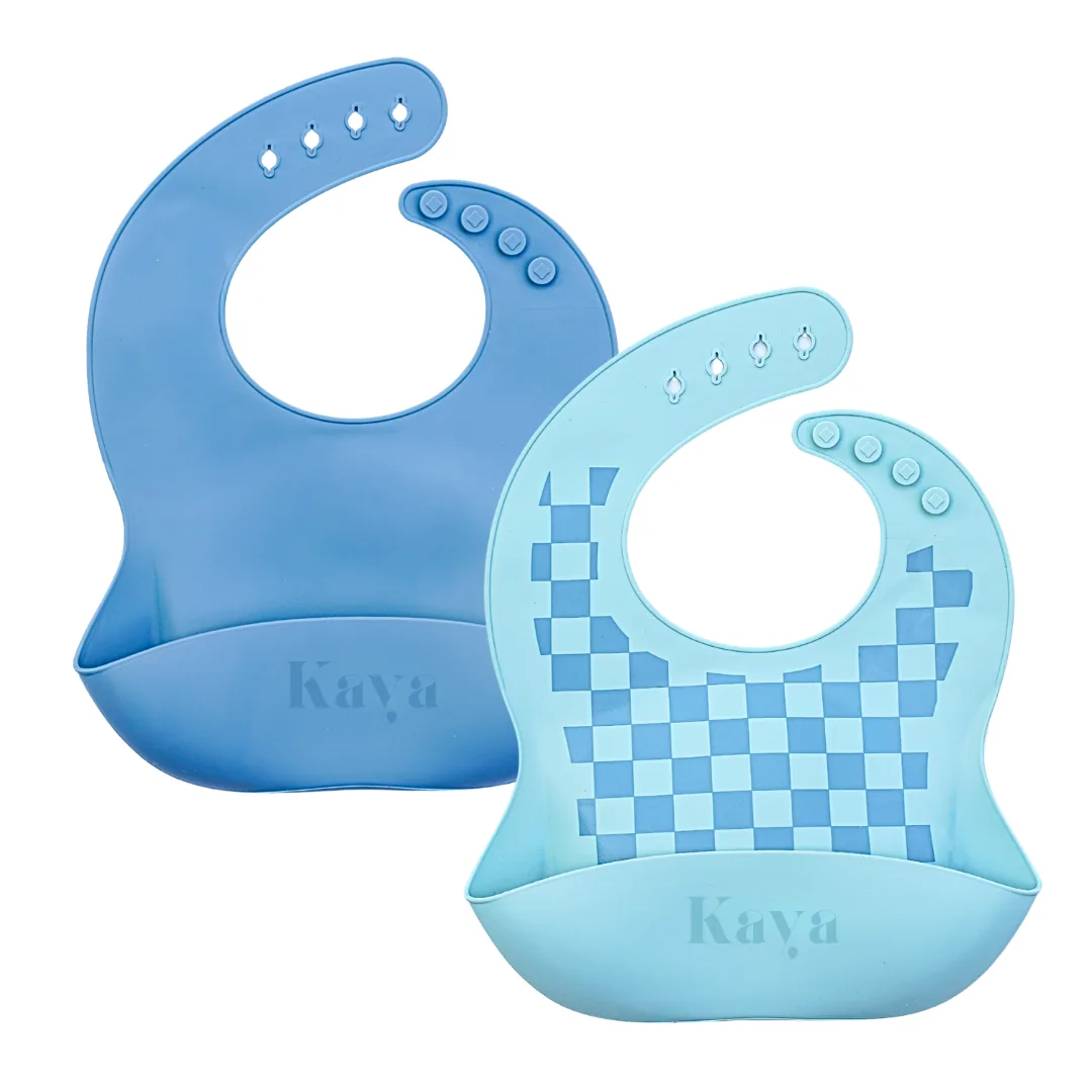 KAYA 2-pack of silicone baby bibs: a slate blue bib and a light blue checkered bib, each with a food-catcher pocket and adjustable snap neck